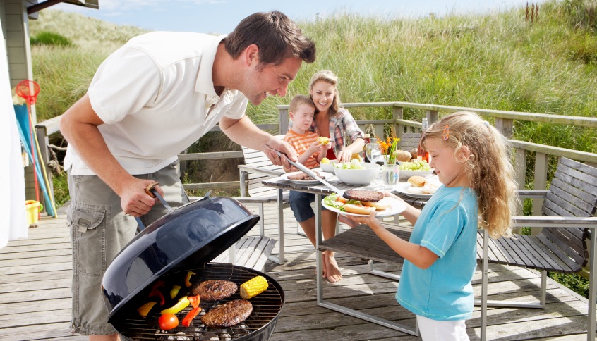 Family on vacation having barbecue