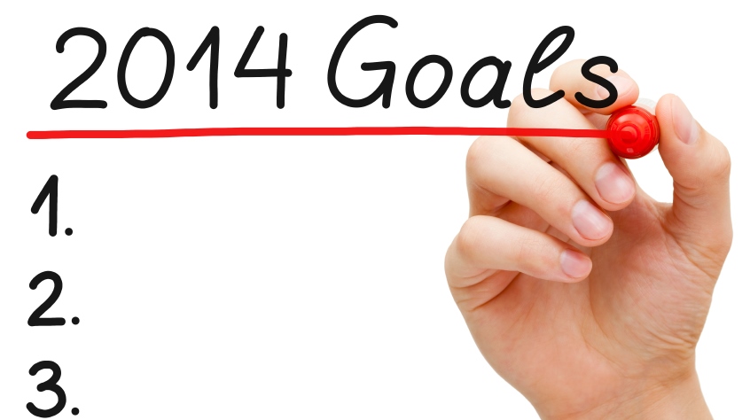 Hand underlining 2014 Goals with red marker isolated on white.