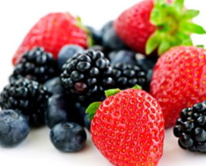 Closeup of assorted fresh berries isolated on white background
