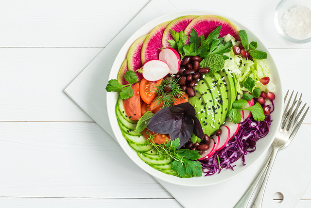vegan lunch bowl. Avocado, red bean, tomato, cucumber, red cabbage  and watermelon radish  vegetables salad. healhty food. Top view